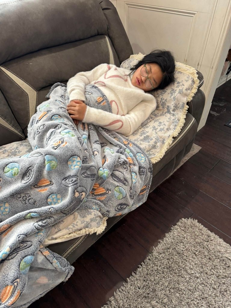 Adaline Deal sleeps on a couch
