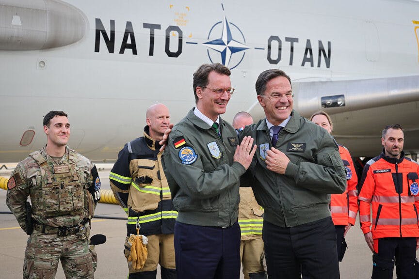 GEILENKIRCHEN, GERMANY - NOVEMBER 13: NATO Secretary General Mark Rutte and North Rhine-Westphalia Premier Hendrik Wuest, dressed with flight jackets, stand in front of an E-3A AWACS (Airborne Warning and Control System) airplane while visiting the NATO Geilenkirchen Air Base on November 13, 2025 in Geilenkirchen, Germany. The base is the headquarters of the NATO Airborne Early Warning & Control Force (NAEW&CF). (Photo by Andreas Rentz/Getty Images)